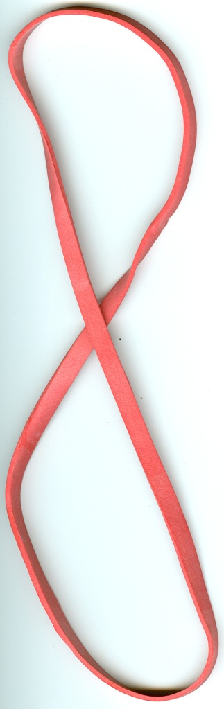 A large rubber band, about a foot long when relaxed and at least a quarter inch wide. Without a resonator it has little recordable sonic signature, not much more than a dull rumble.